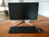 an image of a computer monitor and keyboard on a desk