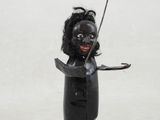 figurine représentant une femme tenant un bâton à la main