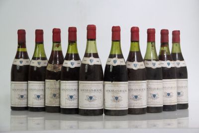six bottles of wine are lined up in a row on a table