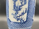 a blue and white vase sitting on a table