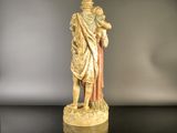 a statue of a man holding a child on a table