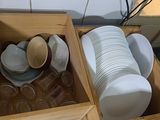 a wooden box filled with plates and bowls