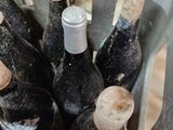 several bottles of wine are in a metal container on a table