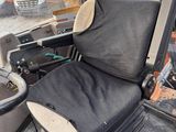 an image of a truck with a seat and a bucket