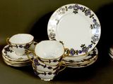 a lot of plates and cups that are on the table