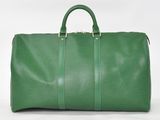 a green duffel bag sitting on top of a white surface