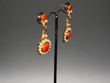 a pair of coral and pearl earrings
