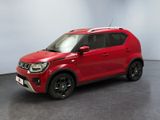 a red car is parked in a room with a white wall