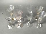 several empty wine glasses sitting on top of a table next to each other