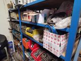 a blue shelf filled with assorted items in a garage