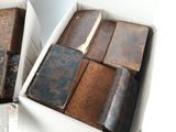 many old books in a box on the floor
