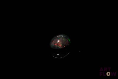 an image of a red and black object in the dark