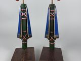 two wooden sculptures of a bird and a bird on a wooden stand