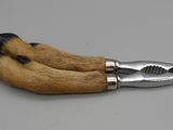a close up of a knife with a dog ' s paw on it