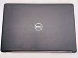dell laptop with dell logo on the screen on a white surface