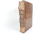 a small bird sitting on top of an old book