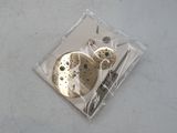 a piece of metal with a clock inside of it