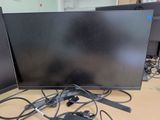 two computer monitors sitting on a table with wires