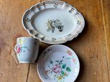 two plates and a bowl on a wooden table