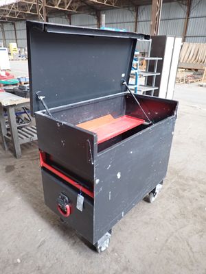 a black box with a red lid sitting in a warehouse