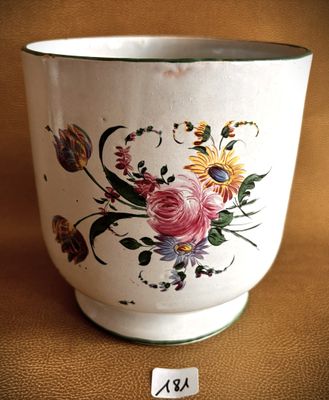 a white cup with a floral design on it