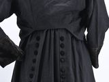 an image of a woman wearing a black coat and black pants