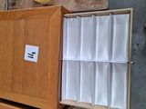 a wooden cabinet with a drawer full of white papers