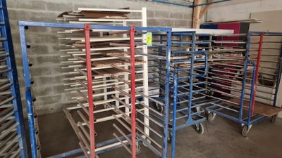 many racks with trays of food on them in a warehouse