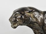 a statue of a cat that is on a table