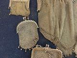 an image of a collection of antique mesh purses on a blue carpet