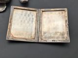 an old book opened on a table next to a cup of coffee
