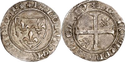 a silver coin with a cross on the front and a shield on the back
