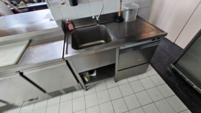 a kitchen with a sink and a refrigerator in it