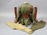 a green jacket and tan pants on a mannequin