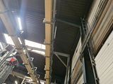 a large room with a lot of windows and a lot of pipes