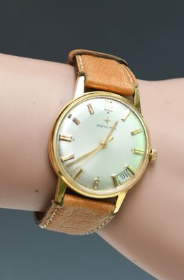 an image of a woman ' s wrist with a watch on it