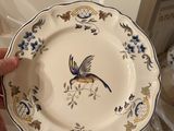 a person holding a plate with a bird on it