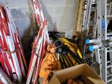 a pile of skis and ski poles in a room