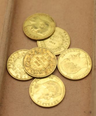 plusieurs pièces d'or posées sur une surface marron