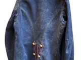 blue jacket with red trims and buttons on a hanger