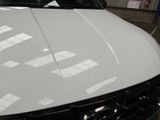 a picture of a white car parked in a garage