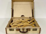 a suitcase with a bunch of wooden spoons inside of it