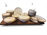 many plates and bowls sitting on a wooden tray
