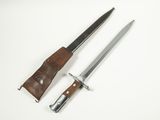 an old knife and sheath on a white surface