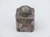 a small silver box with a lid sitting on a white surface