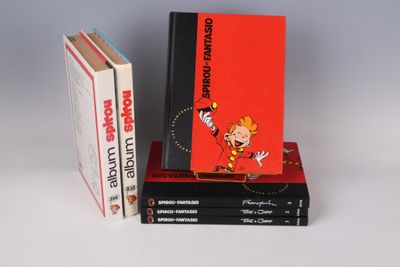 three books are stacked on top of each other on a white surface