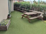 a picnic table on the grass in the backyard
