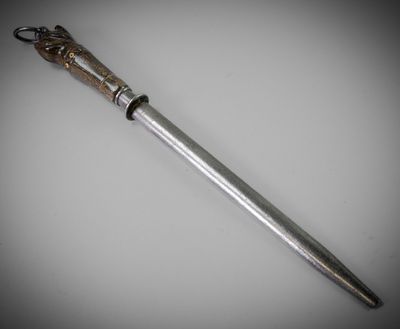 a close up of a knife on a table with a white background
