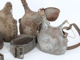 many old metal items that are sitting on a white surface