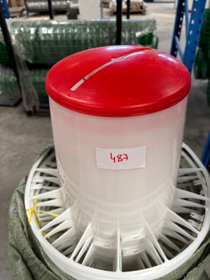 a plastic container with a red lid sitting on top of a rack